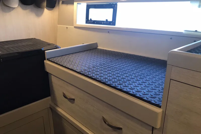 Flip Flops Yacht Photos Pics Interior of a 2017 Leopard 48 yacht with storage drawers and a textured surface.