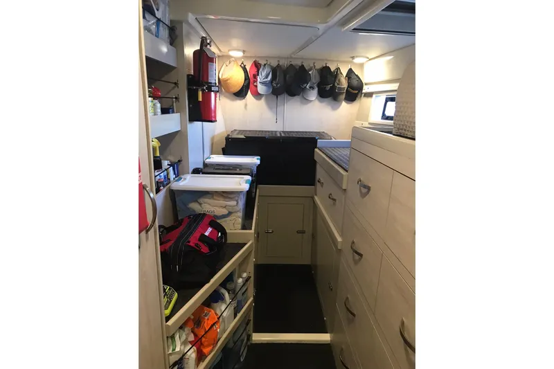 Flip Flops Yacht Photos Pics Interior storage area of a 2017 Leopard 48 yacht with organized shelves and cabinets.