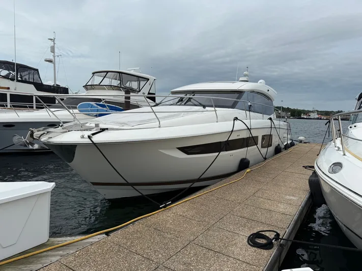Smiles Away Yacht Photos Pics 2018 Prestige 500 S yacht docked at marina under cloudy sky.