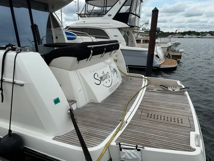 Smiles Away Yacht Photos Pics Luxury yacht Prestige 500 S, 2018 model, docked at marina with wooden deck.
