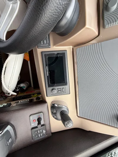 Smiles Away Yacht Photos Pics Control panel of a 2018 Prestige 500 S yacht with steering wheel and navigation controls.