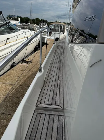 Smiles Away Yacht Photos Pics 2018 Prestige 500 S yacht docked, featuring sleek wooden deck and polished railings.