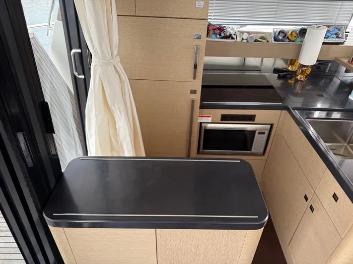 Smiles Away Yacht Photos Pics Modern kitchen interior on a 2018 Prestige 500 S yacht, featuring sleek cabinetry and appliances.