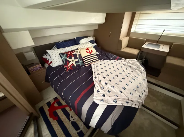 Smiles Away Yacht Photos Pics Luxurious cabin interior of 2018 Prestige 500 S yacht with nautical-themed bedding.