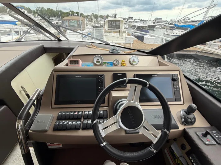Smiles Away Yacht Photos Pics Helm of 2018 Prestige 500 S yacht with navigation controls and marina view.