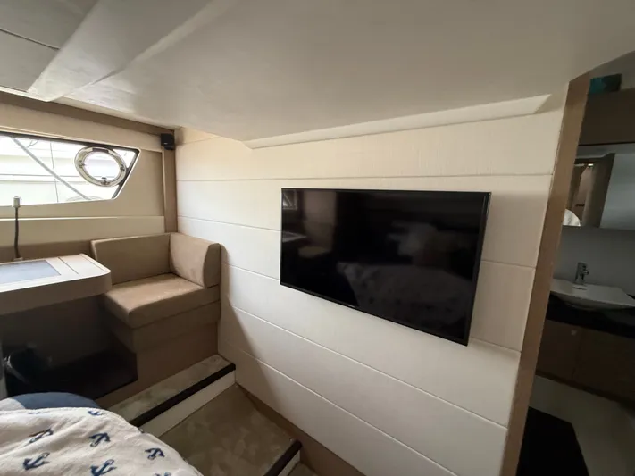 Smiles Away Yacht Photos Pics Interior of 2018 Prestige 500 S yacht with TV and seating area.