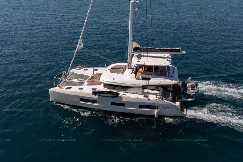  Yacht Photos Pics 2023 Lagoon 55 yacht sailing on open sea, showcasing sleek design and luxury features.