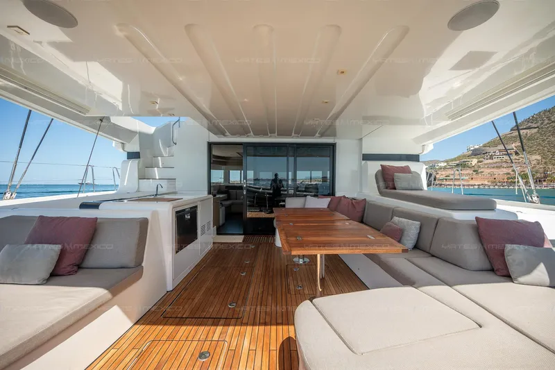  Yacht Photos Pics Luxurious 2023 Lagoon 55 yacht interior with spacious seating and elegant wooden table.