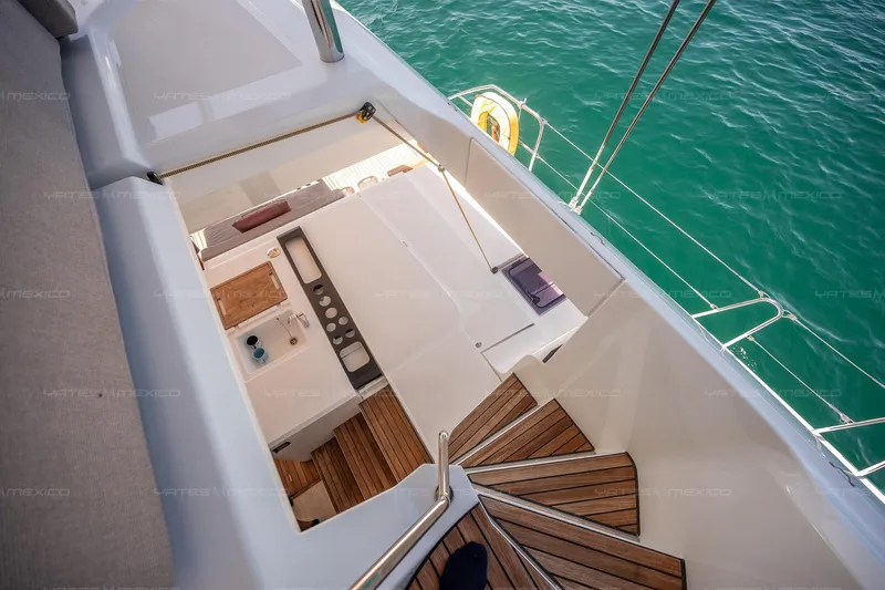 Yacht Photos Pics Staircase on 2023 Lagoon 55 yacht leading to deck with ocean view.
