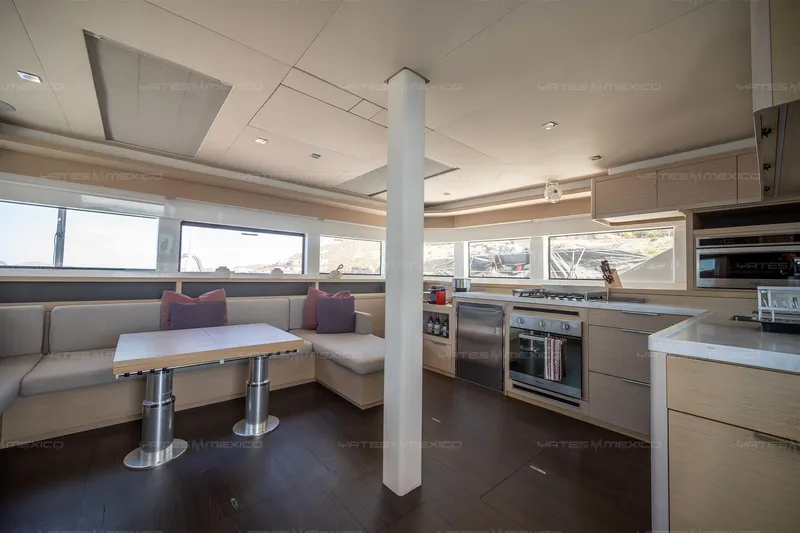  Yacht Photos Pics Modern interior of 2023 Lagoon 55 yacht with kitchen and seating area.