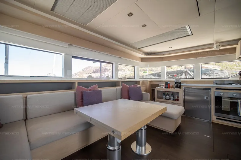  Yacht Photos Pics Luxurious interior of 2023 Lagoon 55 yacht with modern seating and kitchen area.