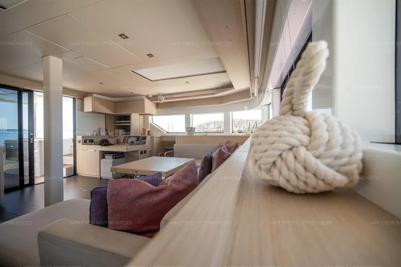  Yacht Photos Pics Modern interior of 2023 Lagoon 55 yacht with cozy seating and nautical decor.