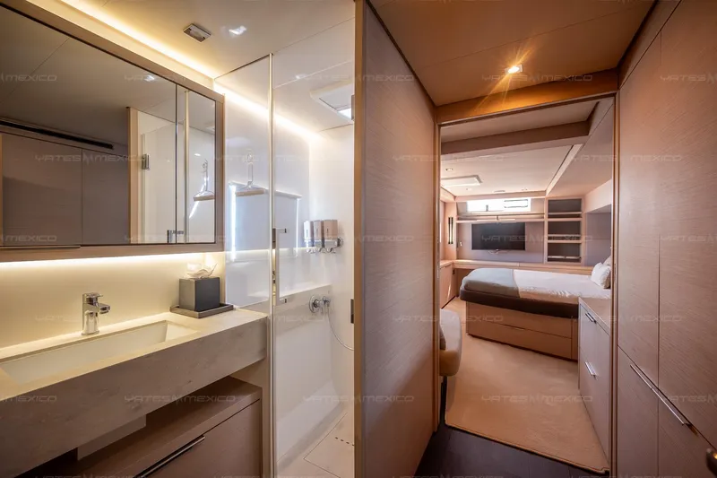  Yacht Photos Pics Luxurious interior of 2023 Lagoon 55 yacht featuring modern bathroom and cozy bedroom.