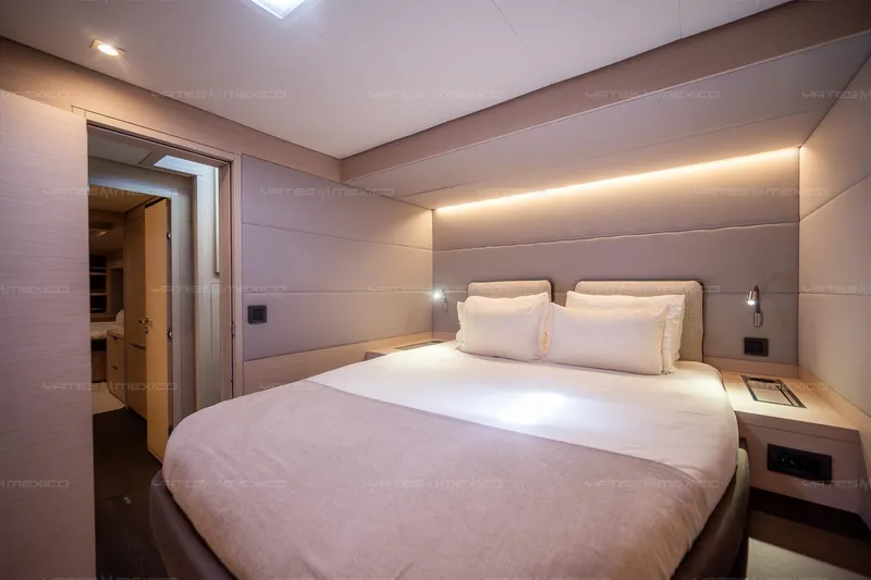 Yacht Photos Pics Luxurious bedroom interior of 2023 Lagoon 55 yacht with modern lighting and cozy bedding.