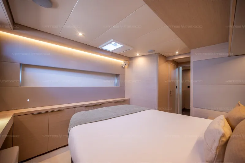  Yacht Photos Pics Luxurious interior of 2023 Lagoon 55 yacht bedroom with modern design and ambient lighting.