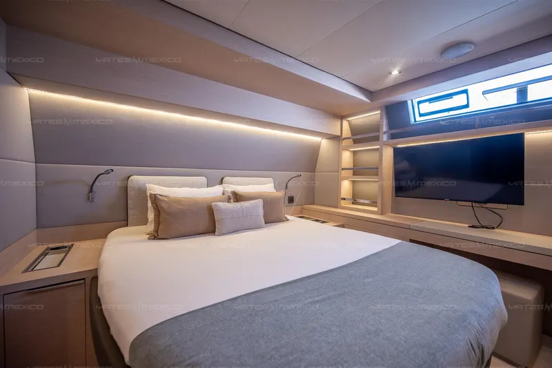  Yacht Photos Pics Luxurious bedroom interior of 2023 Lagoon 55 yacht with modern design and ambient lighting.