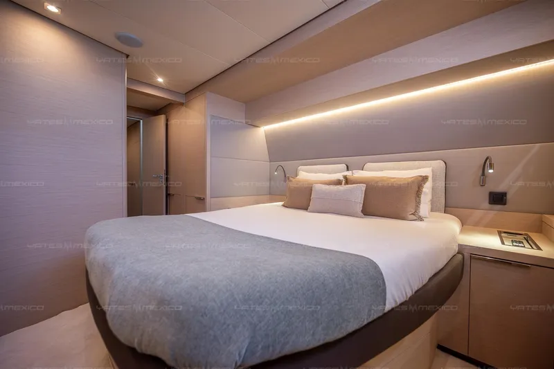  Yacht Photos Pics Luxurious bedroom interior of 2023 Lagoon 55 yacht, featuring modern design and ambient lighting.