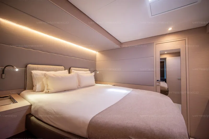  Yacht Photos Pics Luxurious bedroom interior of 2023 Lagoon 55 yacht with modern lighting and cozy bedding.