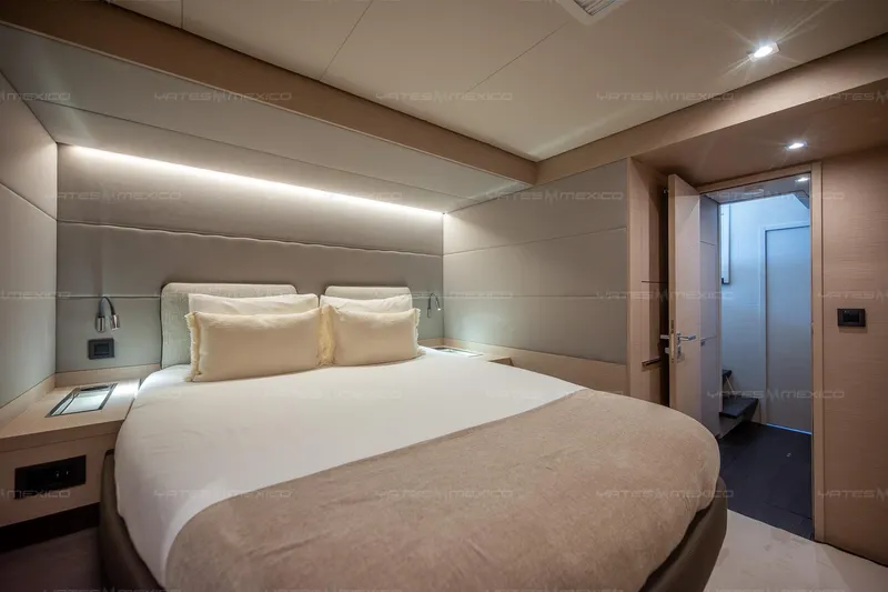  Yacht Photos Pics Luxurious bedroom interior of 2023 Lagoon 55 yacht with modern design and ambient lighting.