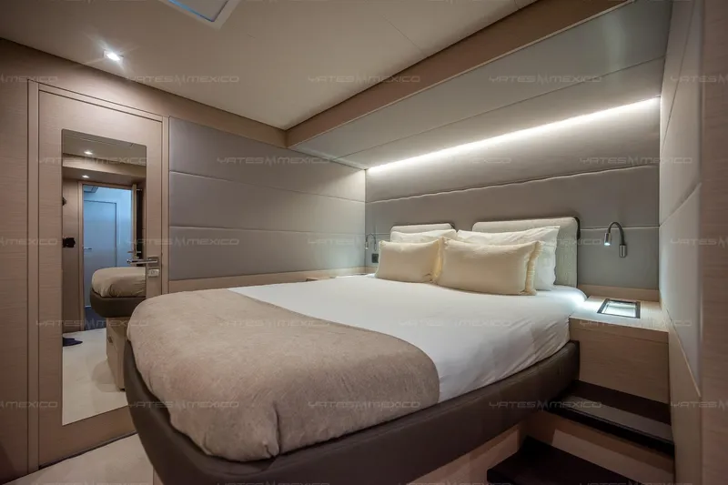  Yacht Photos Pics Luxurious bedroom interior of 2023 Lagoon 55 yacht with modern design and ambient lighting.
