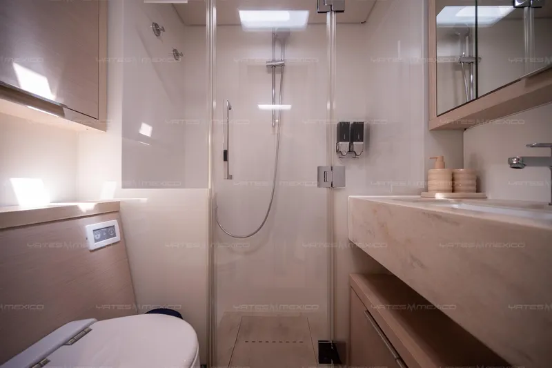  Yacht Photos Pics Modern bathroom in 2023 Lagoon 55 yacht with shower and sleek fixtures.
