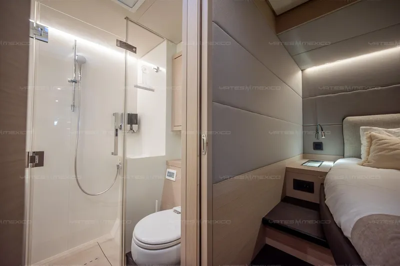  Yacht Photos Pics Luxurious 2023 Lagoon 55 yacht interior with modern bathroom and cozy bedroom.