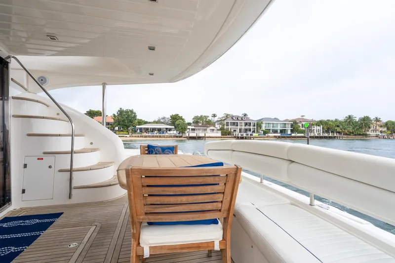  Yacht Photos Pics Luxurious Sunseeker Manhattan 70 yacht deck with seating, table, and waterfront view, 2008 model.