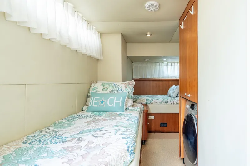  Yacht Photos Pics Cozy cabin interior of 2008 Sunseeker Manhattan 70 yacht with twin beds and nautical decor.