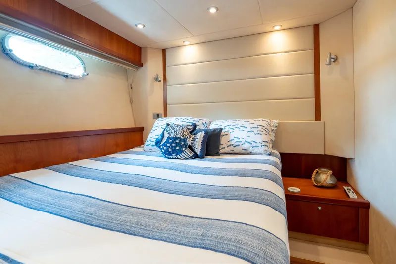  Yacht Photos Pics Luxurious bedroom interior of 2008 Sunseeker Manhattan 70 yacht with striped bedding.