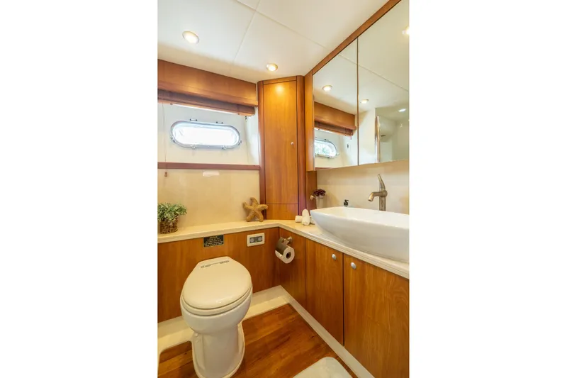  Yacht Photos Pics Luxurious bathroom in 2008 Sunseeker Manhattan 70 yacht with modern fixtures and wooden cabinetry.