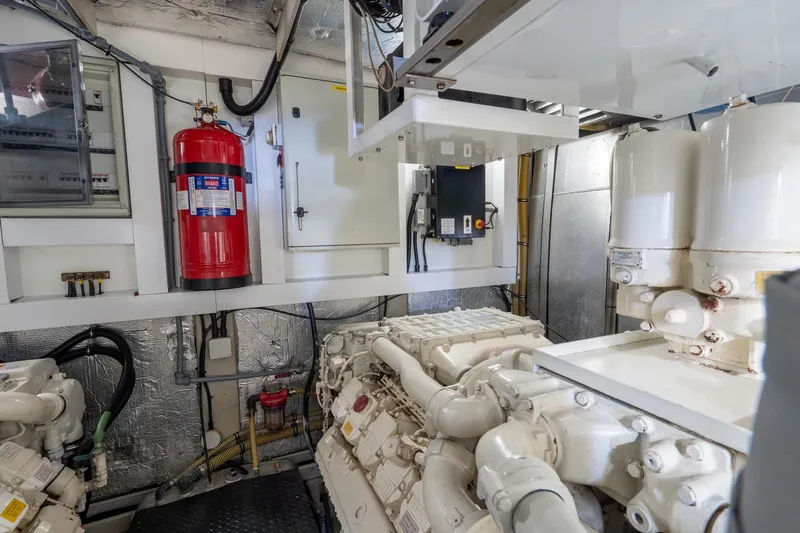  Yacht Photos Pics Engine room of 2008 Sunseeker Manhattan 70 yacht with machinery and fire extinguisher.