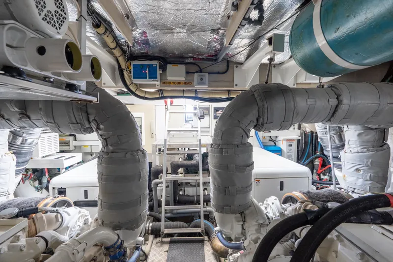  Yacht Photos Pics Engine room of 2008 Sunseeker Manhattan 70 yacht, featuring complex machinery and insulated pipes.