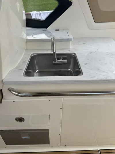  Yacht Photos Pics 2023 Scout 277 Dorado boat interior with sleek sink and countertop design.