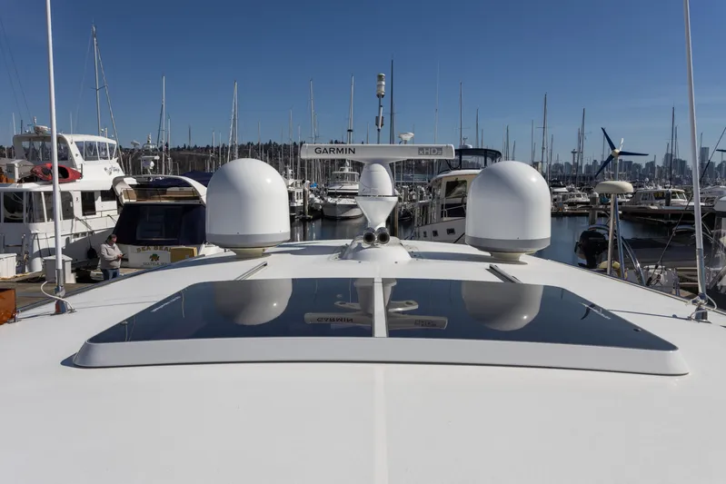 Yeomalt Yacht Photos Pics 2014 Grand Banks 50 Eastbay SX yacht docked at a marina with other boats.