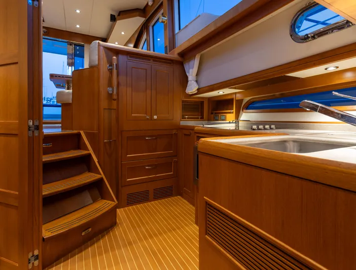 Yeomalt Yacht Photos Pics Interior of 2014 Grand Banks 50 Eastbay SX yacht with wooden cabinetry and modern fixtures.