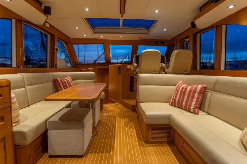 Yeomalt Yacht Photos Pics Luxurious interior of 2014 Grand Banks 50 Eastbay SX yacht with plush seating and wooden finishes.