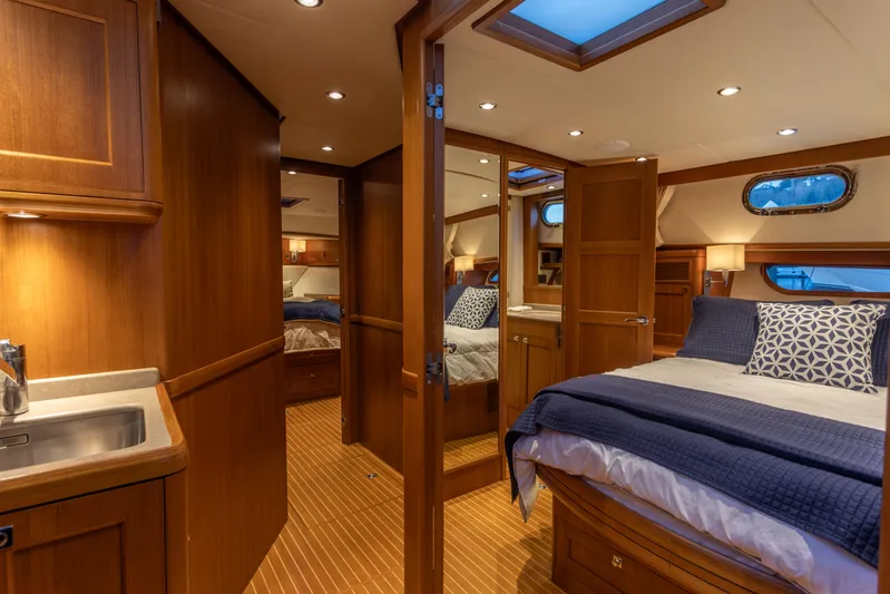 Yeomalt Yacht Photos Pics Luxurious cabin interior of 2014 Grand Banks 50 Eastbay SX yacht with wooden finishes.