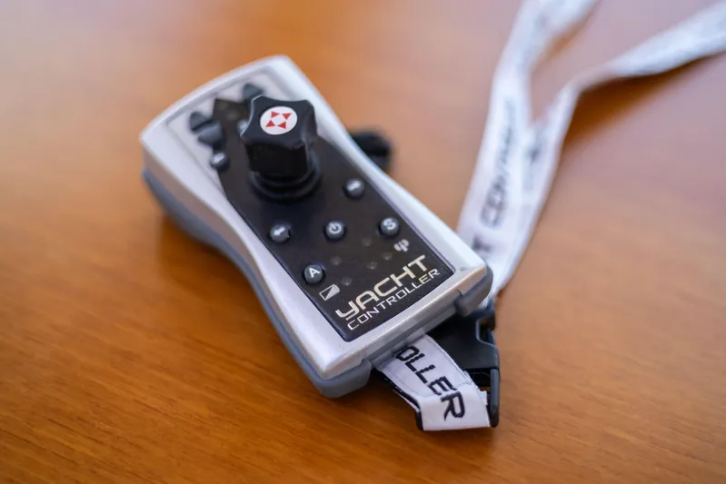 Yeomalt Yacht Photos Pics Yacht controller for 2014 Grand Banks 50 Eastbay SX on wooden surface.