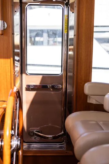 Yeomalt Yacht Photos Pics Interior view of 2014 Grand Banks 50 Eastbay SX yacht with wooden accents and leather seating.