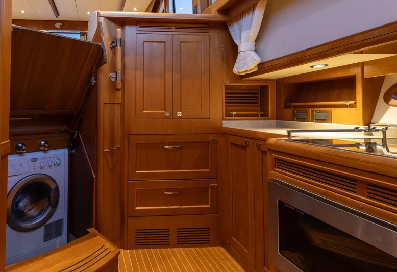 Yeomalt Yacht Photos Pics Interior of 2014 Grand Banks 50 Eastbay SX yacht with wooden cabinetry and built-in appliances.