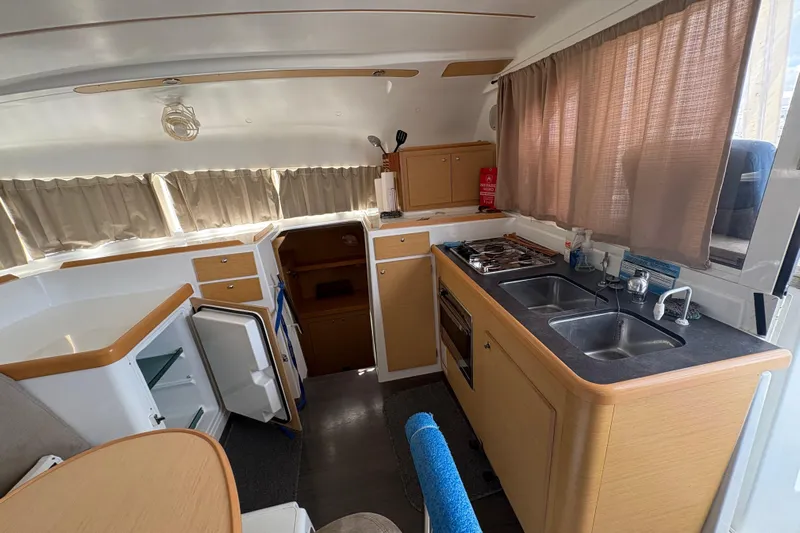 Toucan Deux Yacht Photos Pics Interior of 2004 Lagoon 380 catamaran kitchen with dual sinks and stove.