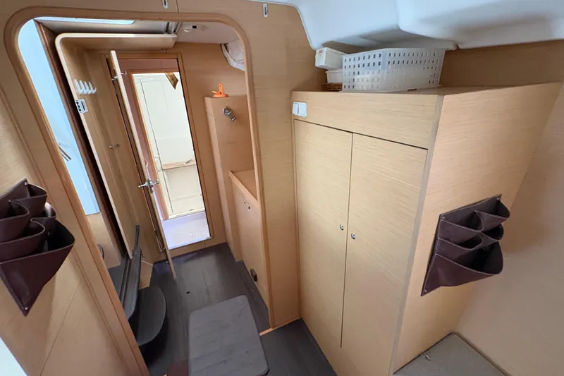 Toucan Deux Yacht Photos Pics Interior of 2004 Lagoon 380 catamaran, featuring wooden cabinetry and compact design.