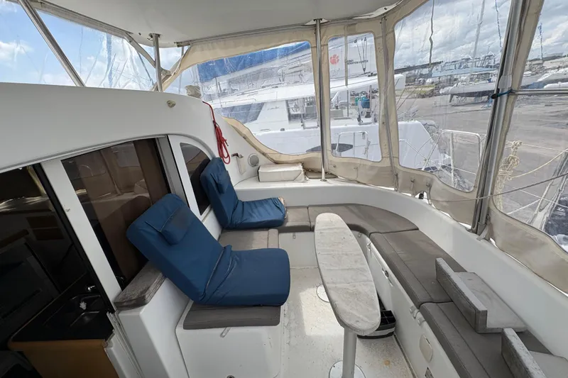 Toucan Deux Yacht Photos Pics Interior view of 2004 Lagoon 380 catamaran with seating and table.