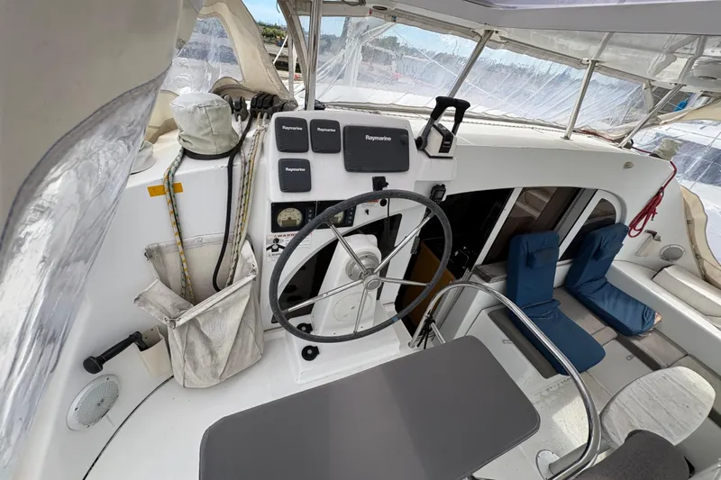 Toucan Deux Yacht Photos Pics Cockpit of 2004 Lagoon 380 catamaran with steering wheel and navigation equipment.