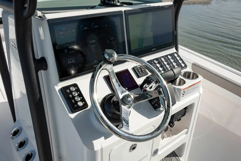  Yacht Photos Pics 2024 Caymas 281 HB boat dashboard with dual screens and chrome steering wheel.