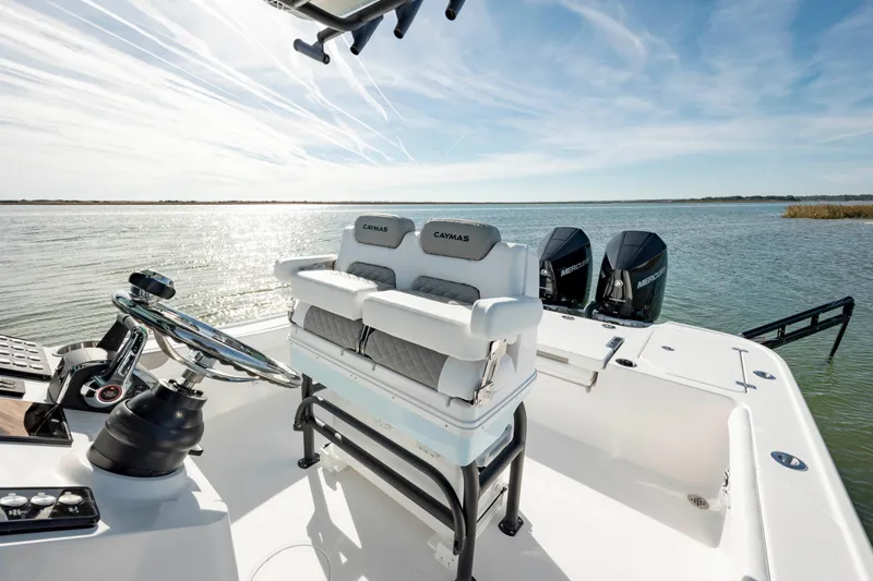  Yacht Photos Pics 2024 Caymas 281 HB boat interior with dual outboard motors on a sunny day.