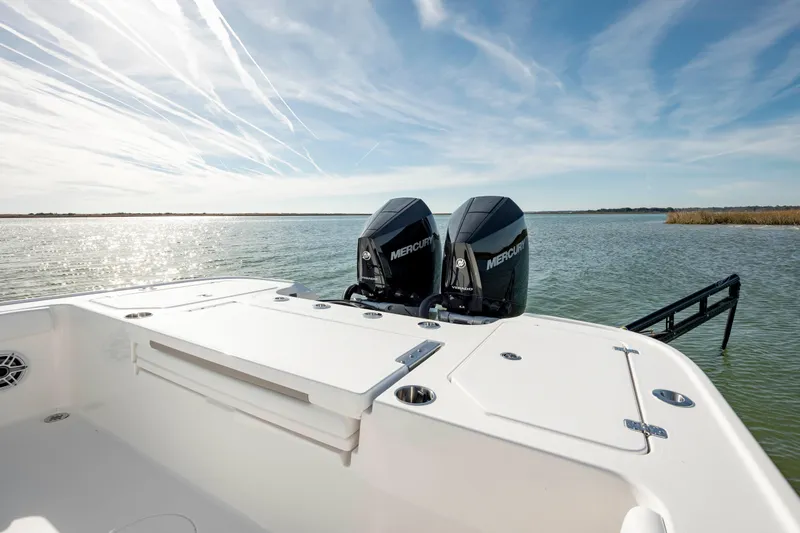  Yacht Photos Pics 2024 Caymas 281 HB boat with dual Mercury engines on a serene lake.