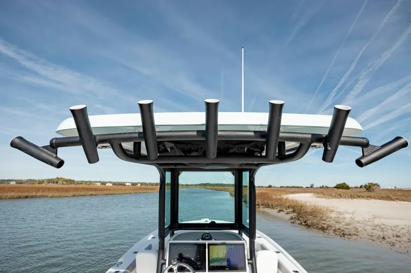  Yacht Photos Pics 2024 Caymas 281 HB boat with rod holders on a calm waterway.