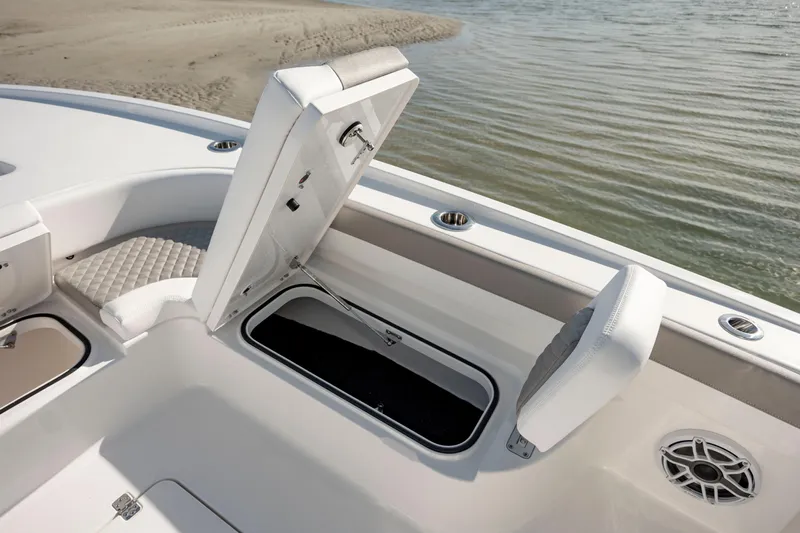  Yacht Photos Pics 2024 Caymas 281 HB boat storage compartment and seating area near water.