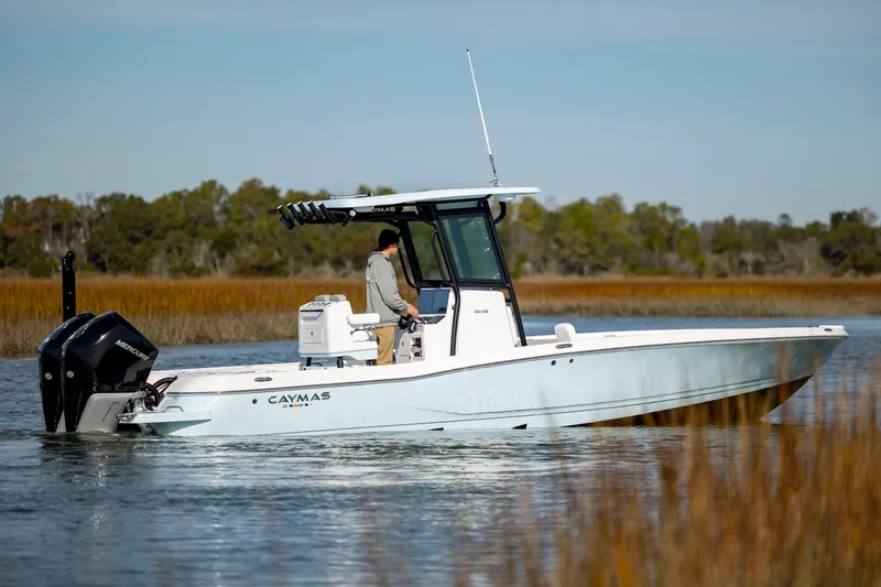  Yacht Photos Pics 2024 Caymas 281 HB boat cruising on a calm lake.